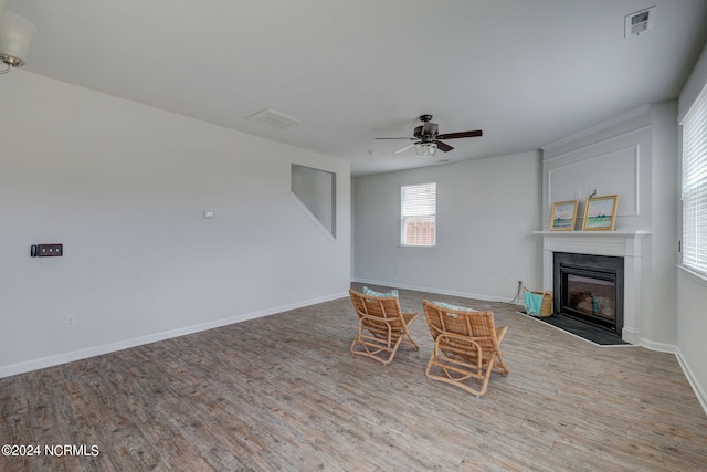 unfurnished living room featuring light hardwood / wood-style flooring and ceiling fan