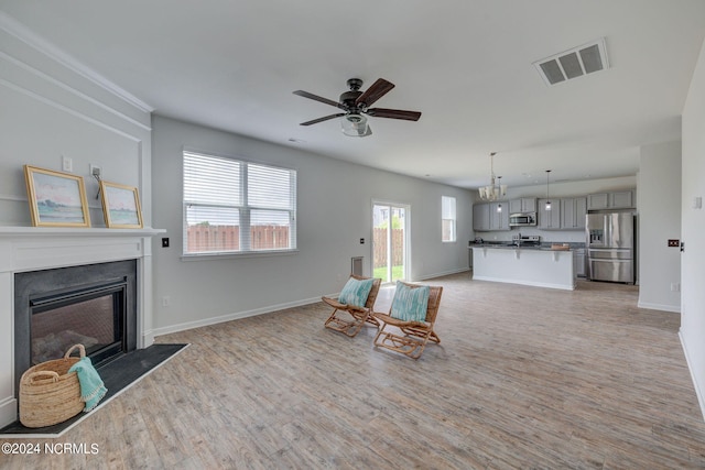 living room with light hardwood / wood-style floors and ceiling fan