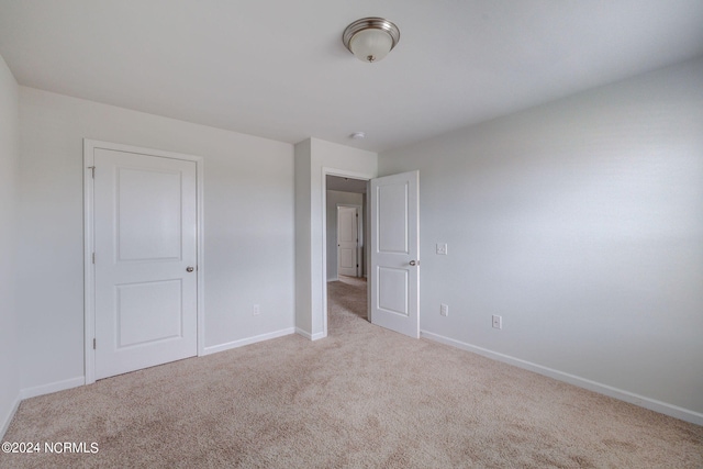 unfurnished bedroom with light carpet