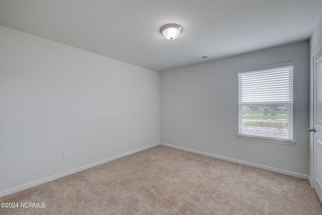 unfurnished room with light colored carpet