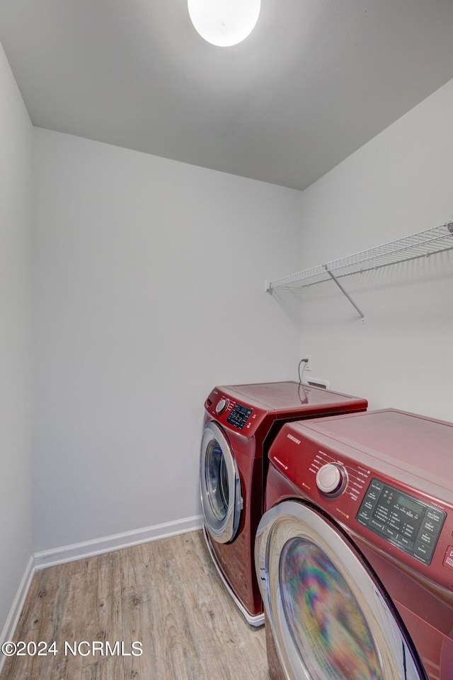 laundry area featuring hardwood / wood-style flooring and independent washer and dryer