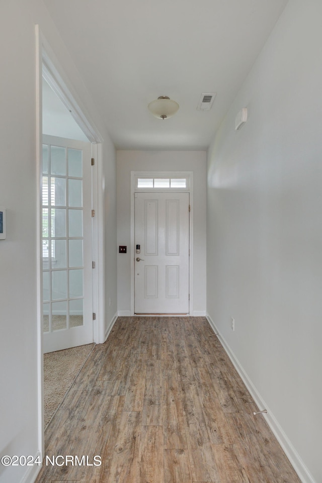 entryway with wood-type flooring