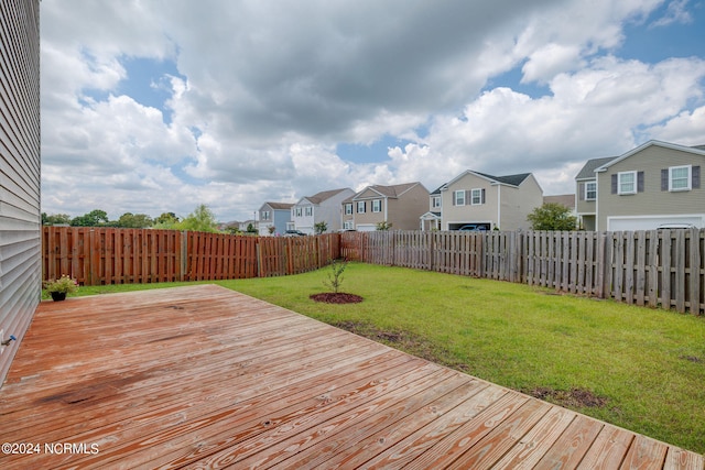 wooden terrace featuring a lawn