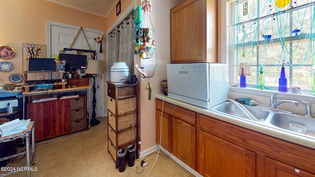 kitchen featuring sink and light tile patterned floors