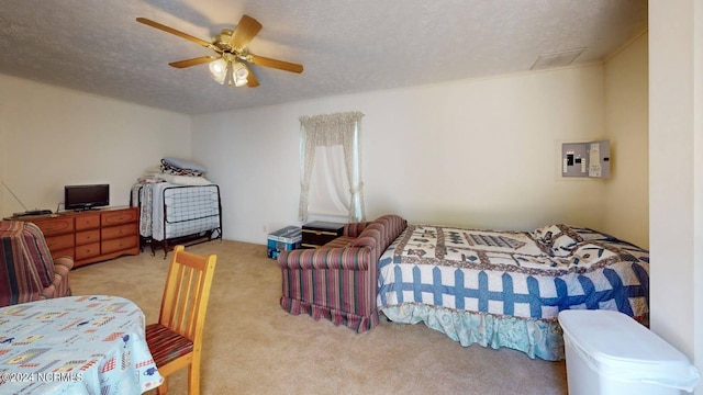 bedroom featuring ceiling fan, light colored carpet, and a textured ceiling