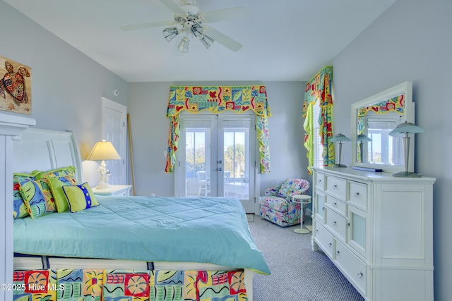 bedroom with access to outside, french doors, multiple windows, and carpet