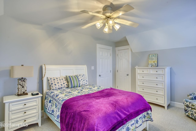 bedroom with light colored carpet, ceiling fan, and baseboards