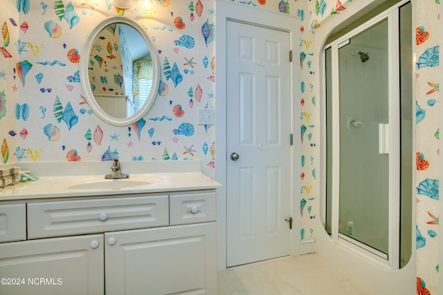 bathroom with a shower stall, vanity, and wallpapered walls