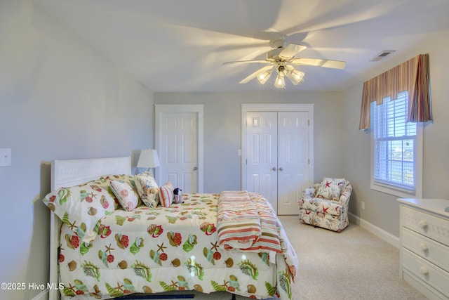 bedroom featuring light colored carpet, a ceiling fan, baseboards, visible vents, and a closet