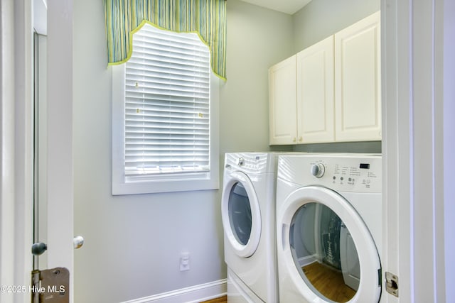 laundry area with cabinet space and separate washer and dryer