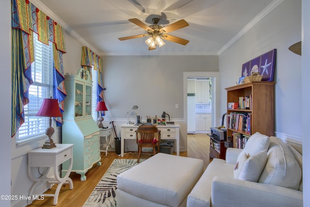 interior space featuring crown molding, a ceiling fan, and wood finished floors