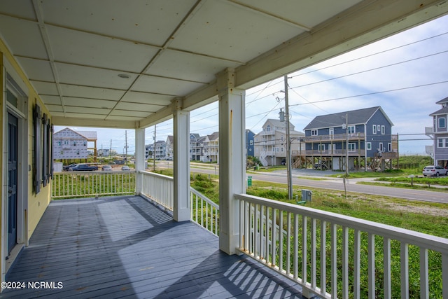 wooden deck with covered porch and a residential view