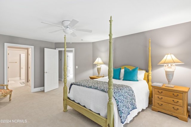 bedroom with light carpet, ensuite bath, and ceiling fan