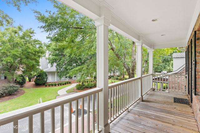 wooden deck featuring a yard