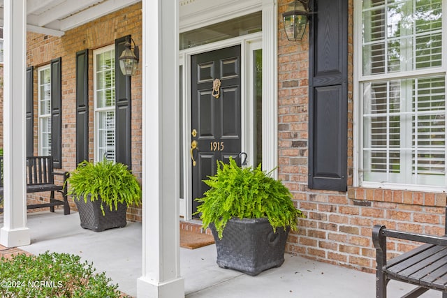 doorway to property featuring a porch