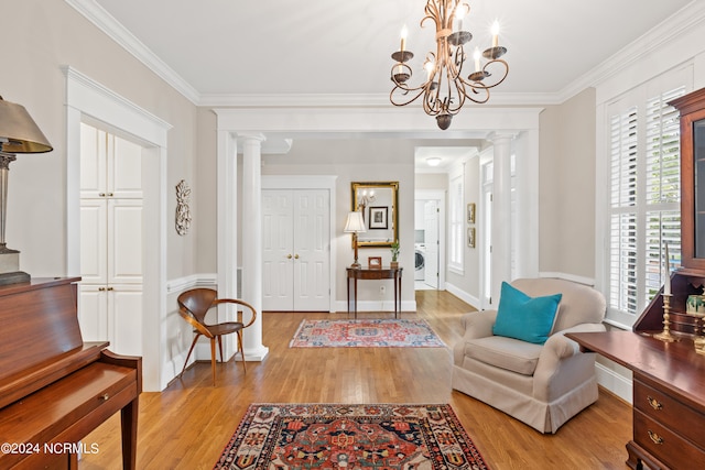 interior space featuring a healthy amount of sunlight, ornate columns, and light hardwood / wood-style floors