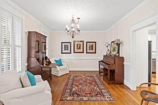 living room featuring wood-type flooring, ornamental molding, and a healthy amount of sunlight