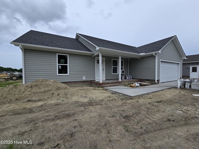 235 Nugget Trl, Elizabeth City, NC 27909 - ranch-style house with covered porch, an attached garage, a shingled roof, and driveway