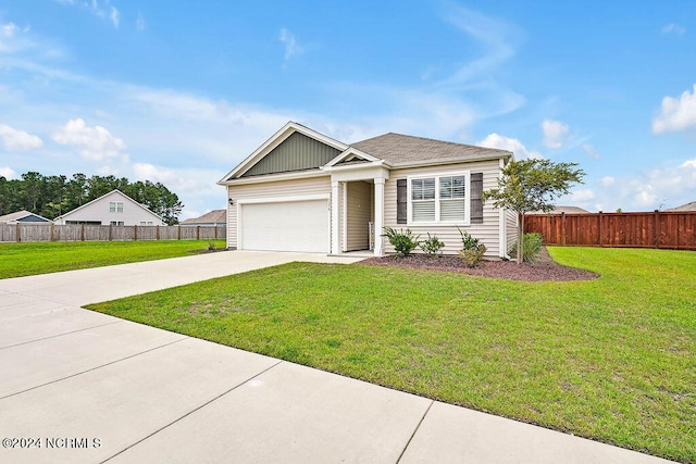 view of front of home with a garage and a front lawn