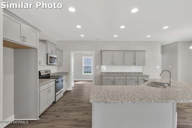 unfurnished dining area with ceiling fan with notable chandelier and hardwood / wood-style floors