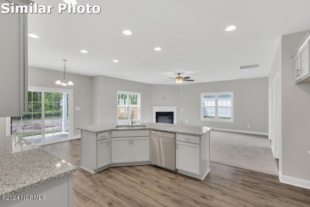 unfurnished living room with carpet floors, a wealth of natural light, and ceiling fan