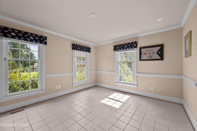 spare room featuring plenty of natural light, crown molding, and light tile patterned flooring