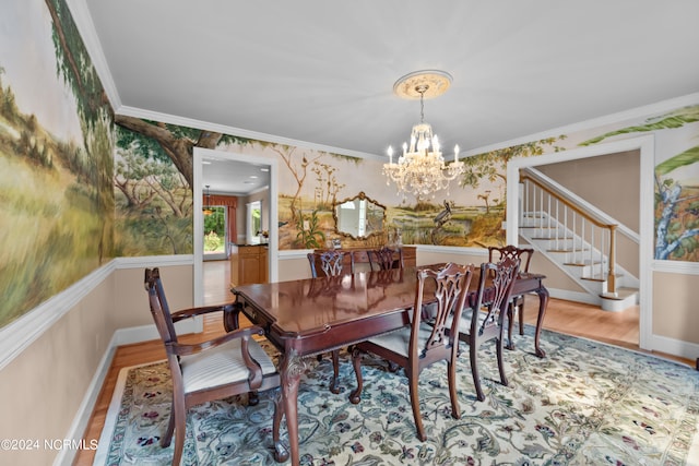 dining space featuring wood-type flooring, a notable chandelier, and ornamental molding