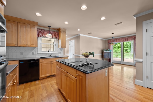 kitchen featuring backsplash, black appliances, light wood-type flooring, a center island, and hanging light fixtures