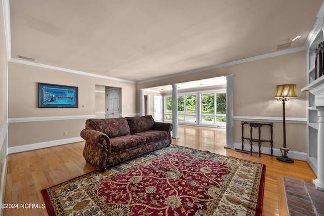 living room featuring light hardwood / wood-style flooring and ornamental molding