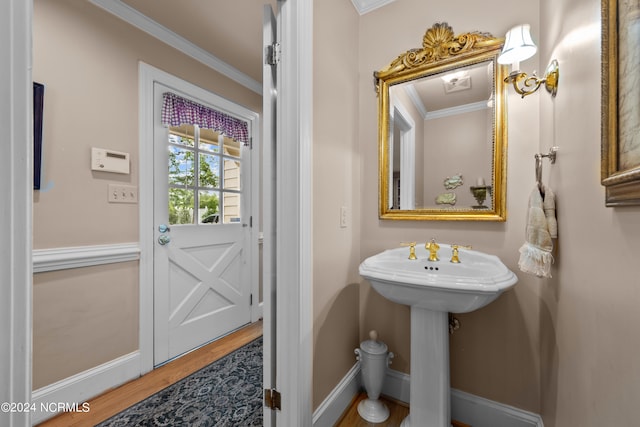 bathroom with hardwood / wood-style floors and ornamental molding