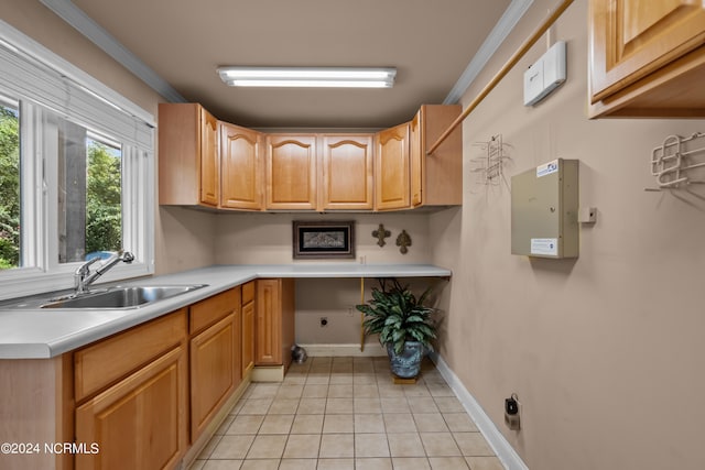 kitchen with light tile patterned floors, sink, and ornamental molding