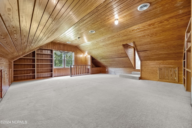 bonus room featuring wood walls, lofted ceiling with skylight, and wooden ceiling