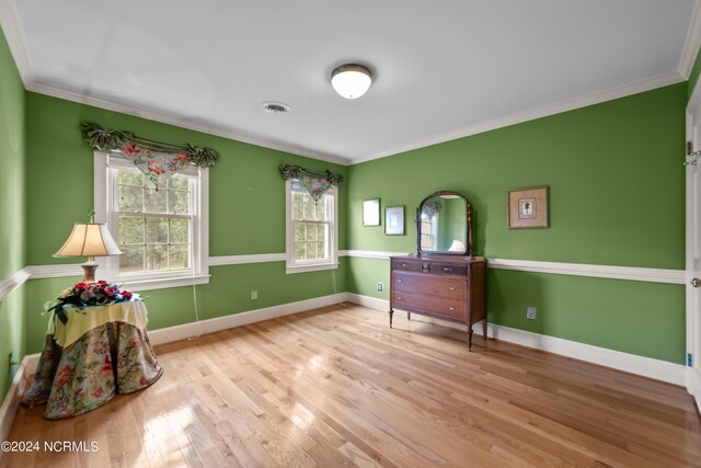 interior space featuring light wood-type flooring and ornamental molding