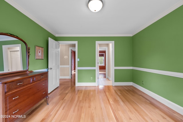 unfurnished bedroom with light hardwood / wood-style flooring and ornamental molding