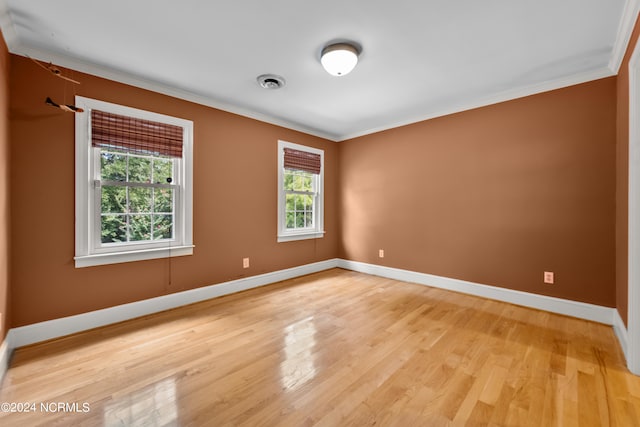 unfurnished room featuring light hardwood / wood-style floors and ornamental molding