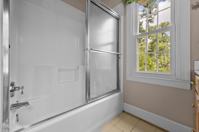 bathroom featuring tile patterned floors, shower / bath combination with glass door, and vanity