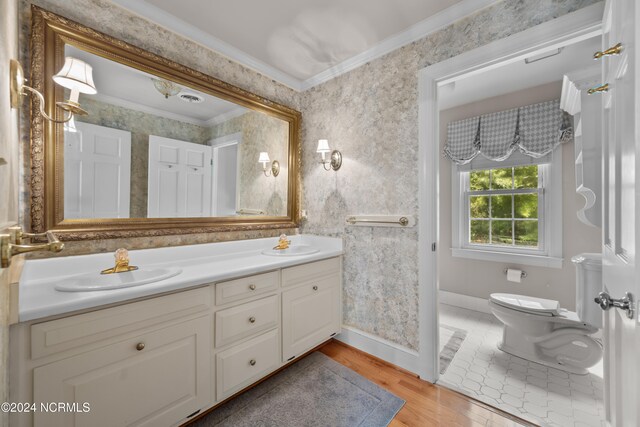 bathroom featuring toilet, hardwood / wood-style floors, crown molding, and vanity