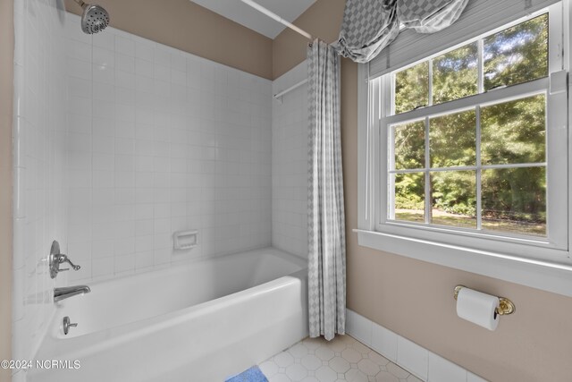 bathroom featuring shower / tub combo, plenty of natural light, and tile patterned flooring