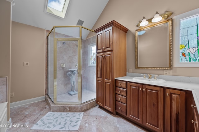 bathroom with tile patterned floors, a shower with door, vanity, and a healthy amount of sunlight