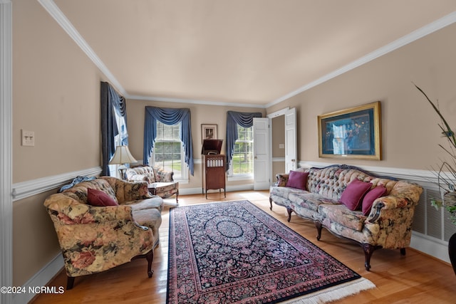 living room featuring light hardwood / wood-style flooring and crown molding