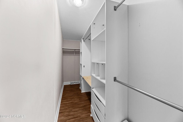 walk in closet with dark wood-style floors and visible vents