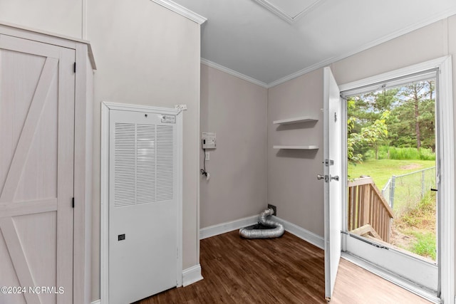 laundry area with dark wood finished floors, a heating unit, crown molding, and baseboards