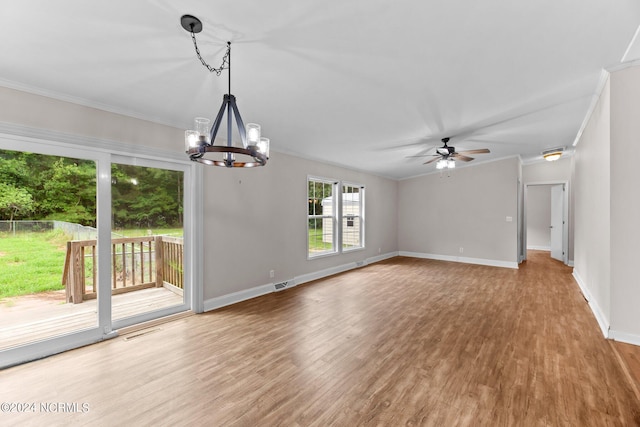 interior space featuring ceiling fan with notable chandelier, wood finished floors, visible vents, baseboards, and ornamental molding