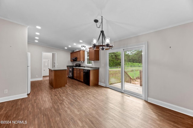 kitchen featuring a kitchen island, brown cabinets, decorative light fixtures, crown molding, and black appliances