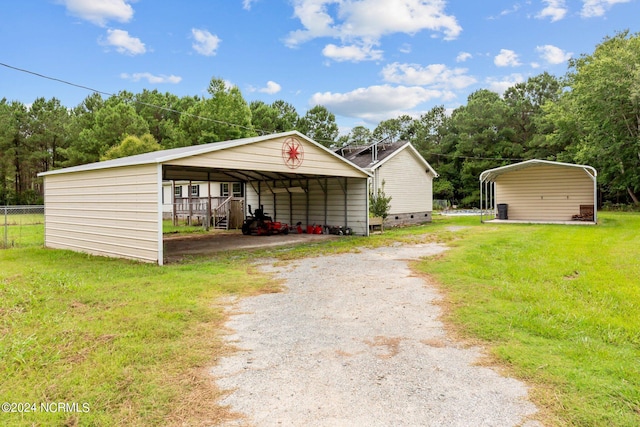 view of outbuilding with a carport and driveway