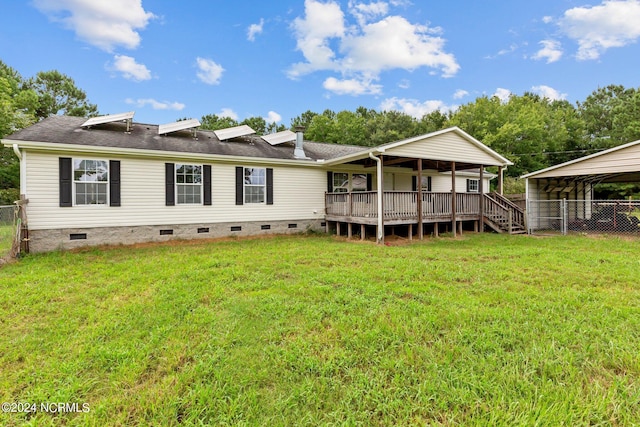 rear view of house with roof with shingles, a lawn, crawl space, fence, and a deck