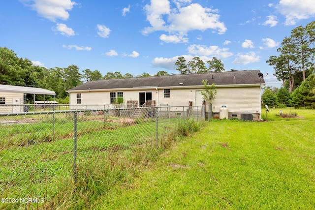 back of house featuring crawl space, a lawn, central air condition unit, and fence