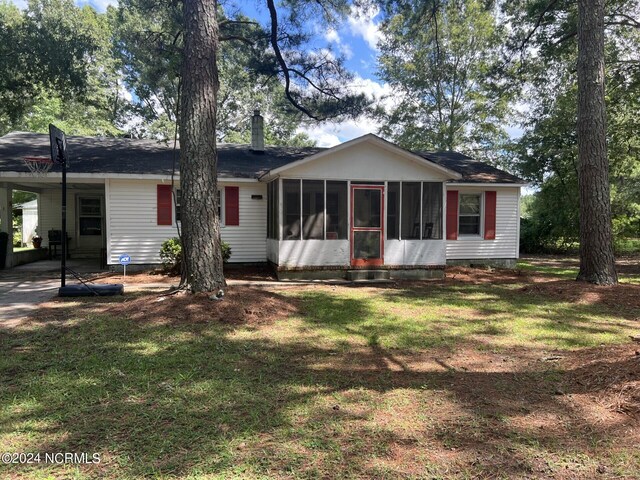 ranch-style home with a sunroom and a front yard