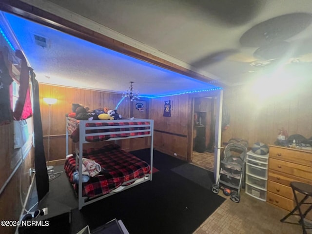 bedroom featuring wood walls and crown molding