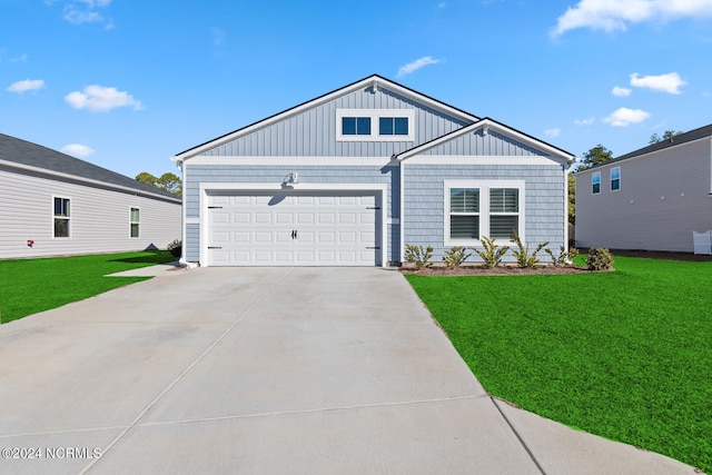 view of front of house with a garage and a front yard